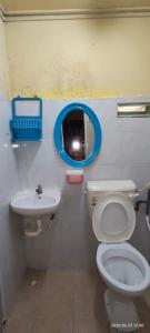 a bathroom with a toilet and a sink at hotel hen hen in Kampong Saleng +20 photos