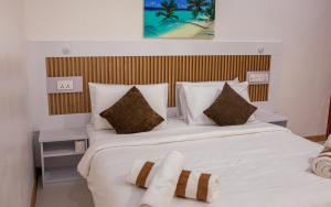 a bedroom with a large bed with white sheets and pillows at Velana View at Mathiveri in Mathiveri