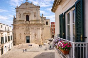 an old building with people walking in front of it at IL PLEBISCITO luxury in centro per davvero in Martina Franca