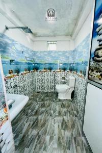 a bathroom with a toilet and a tub and a sink at TM Villa Madiha in Matara