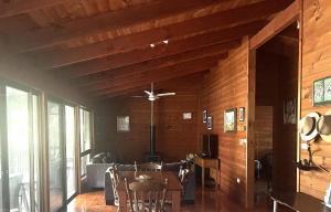 a living room with a ceiling fan and a table at For Rest at Crescent Head in Crescent Head