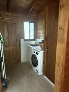 a laundry room with a washer and dryer in a house at For Rest at Crescent Head in Crescent Head +1 photo