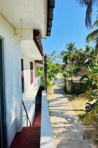 a side view of a building with a sidewalk at TM Villa Madiha in Matara