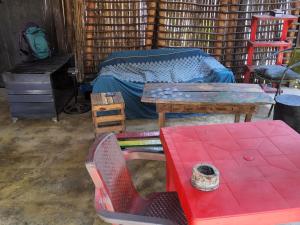a room with a bed and a table and a desk at Hostal & Dormitorio Buena Onda in Palomino +50 photos