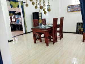 a dining room with a wooden table and chairs at Southern Surf Villa in Dickwella