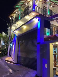 a building with a garage door with blue lights at Southern Surf Villa in Dickwella