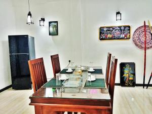 a dining room with a glass table and chairs at Southern Surf Villa in Dickwella +13 photos