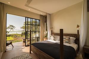 a bedroom with a large bed and a large window at Rubi Ranch Lakehouses in Naivasha +64 photos