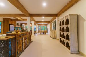 a kitchen with wooden cabinets and a dining room at Santi Villa Wat Seree in Ko Phangan
