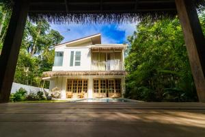 a house with a waterfall over the front yard at Santi Villa Wat Seree in Ko Phangan