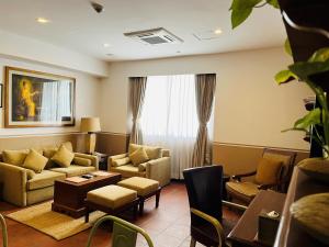 a living room with a couch and chairs and a table at Nepali Ghar Hotel, Thamel - Your Home In Nepal in Kathmandu