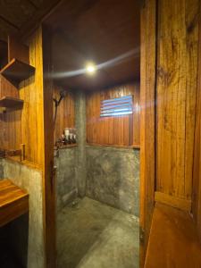 a small room with a window in a wooden room at Camp Olli Beach Villas in Dapa