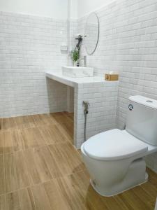 a white bathroom with a toilet and a sink at Suanthara kokut in Ko Kood +37 photos