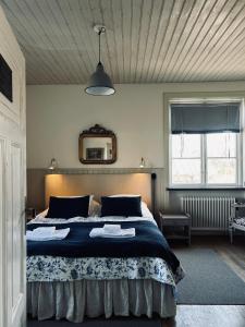 a bedroom with a large bed with a blue blanket at Mellby 11 Bed & Breakfast in Kivik +152 photos