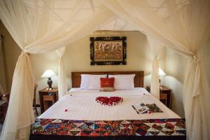 Postel nebo postele na pokoji v ubytování Taruna Boutique Homestay & Spa