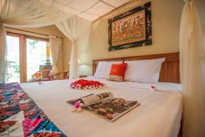 Postel nebo postele na pokoji v ubytování Taruna Boutique Homestay & Spa