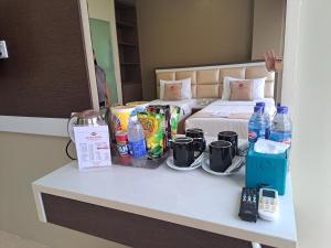 a hotel room with a bed and a table with drinks at osaka hotel batam in Nagoya