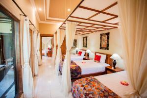 Postel nebo postele na pokoji v ubytování Taruna Boutique Homestay & Spa