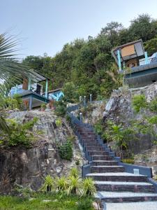 a set of stairs leading up to a house at Sunshine's Hill in Ko Lanta