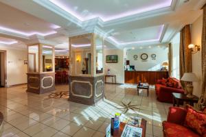 a living room with a fireplace in the middle at Slavyanka Hotel in Chelyabinsk