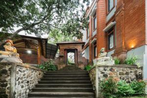 a set of stairs leading to a building at DWM Mandhasativa Homestay By Reccoma in Singaraja