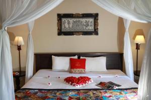 Postel nebo postele na pokoji v ubytování Taruna Boutique Homestay & Spa