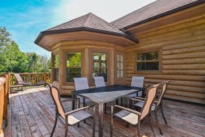 a wooden deck with a table and chairs on it at Fiddler Lake Resort - Deer 73 in Mille-Isles
