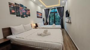 two beds with stuffed animals on them in a room at The Star hotel DTH3-31 in Phú Quốc +127 photos