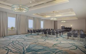a conference room with chairs and a stage in the middle at Hyatt Centric Delfina Santa Monica in Los Angeles +102 photos