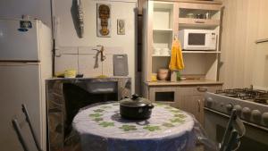 a small kitchen with a table with a pot on it at Hotel Virgen del Carmen - Huaraz in Huaraz