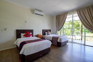 a bedroom with two beds and a large window at Kimana Villa in Manggis +21 photos