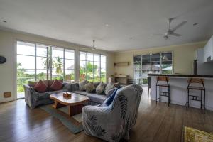 a living room with a couch and a table at Kimana Villa in Manggis