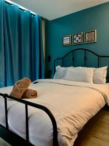 a bed with a teddy bear sitting on top of it at Mersey Residence Koh Samui in Lamai