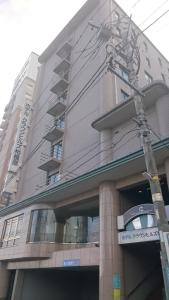 a building with a sign on the front of it at Hotel Crown Hills Sagamihara in Sagamihara