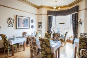 a dining room with a table and chairs at The Leicester in Southport