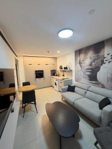 a living room with a couch and a table at perfect vacation in Eilat - סוויטת בוטיק מעוצבת לחופשה מושלמת באילת במתחם U360 in Eilat