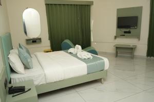 a hospital room with a bed with a stuffed animal on it at Hotel Bandhan in Himatnagar