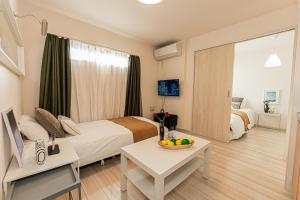 ein Hotelzimmer mit einem Bett und einem Tisch mit einer Obstschale in der Unterkunft Mi-Hotel Ikebukuro 池袋 in Tokio