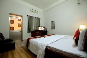 Postel nebo postele na pokoji v ubytování Tan Da Hotel