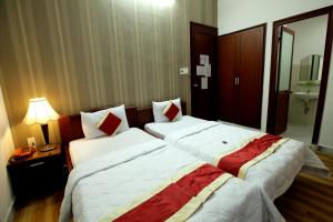 Postel nebo postele na pokoji v ubytování Tan Da Hotel