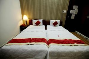 Postel nebo postele na pokoji v ubytování Tan Da Hotel