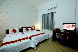 Postel nebo postele na pokoji v ubytování Tan Da Hotel