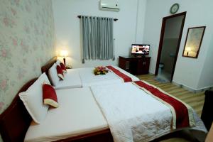 Postel nebo postele na pokoji v ubytování Tan Da Hotel
