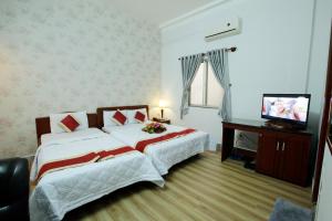 Postel nebo postele na pokoji v ubytování Tan Da Hotel
