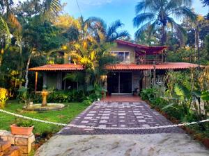 a house with a garden and a fence at El Nido Cerro Azul in Cerro Azul