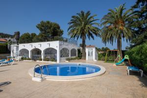 a swimming pool with a slide and a playground at CBA COSTA BRAVA - Cala Morisca in Tossa de Mar