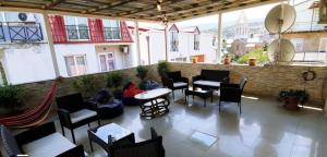 a patio with tables and chairs on a building at DavidL Hotel Tbilisi in Tbilisi City