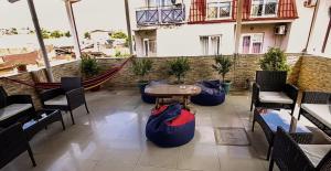 a patio with chairs and a table on a building at DavidL Hotel Tbilisi in Tbilisi City