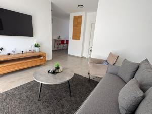 a living room with a couch and a table at דירה בוטיק in Rishon LeẔiyyon