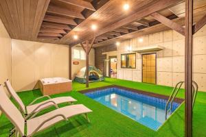 a house with a swimming pool and a tent at Gapyeong Vistahill Pension in Gapyeong